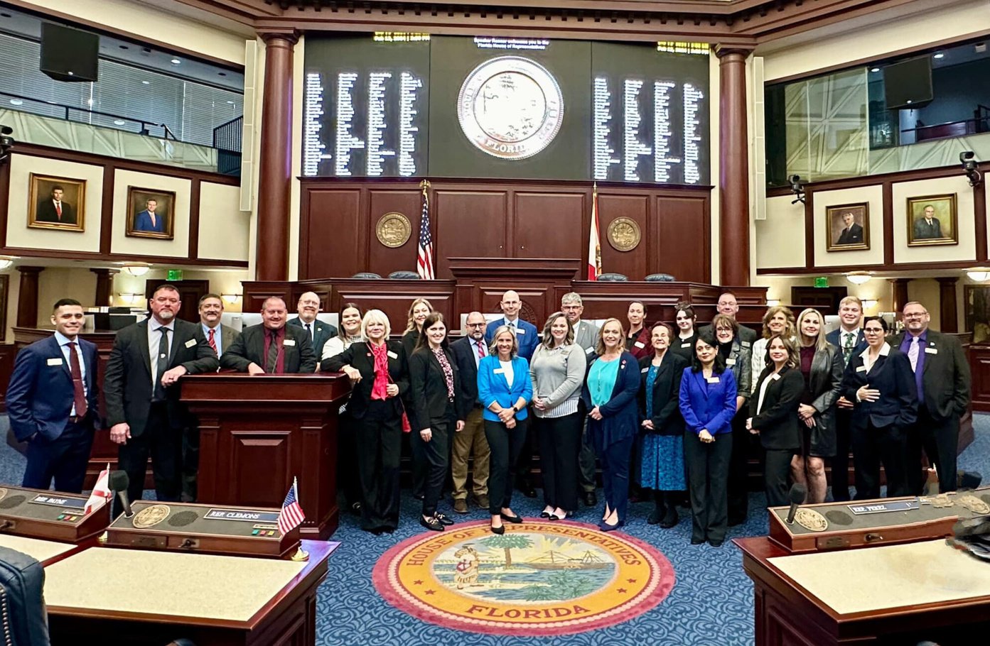 Group standing in state government chambers