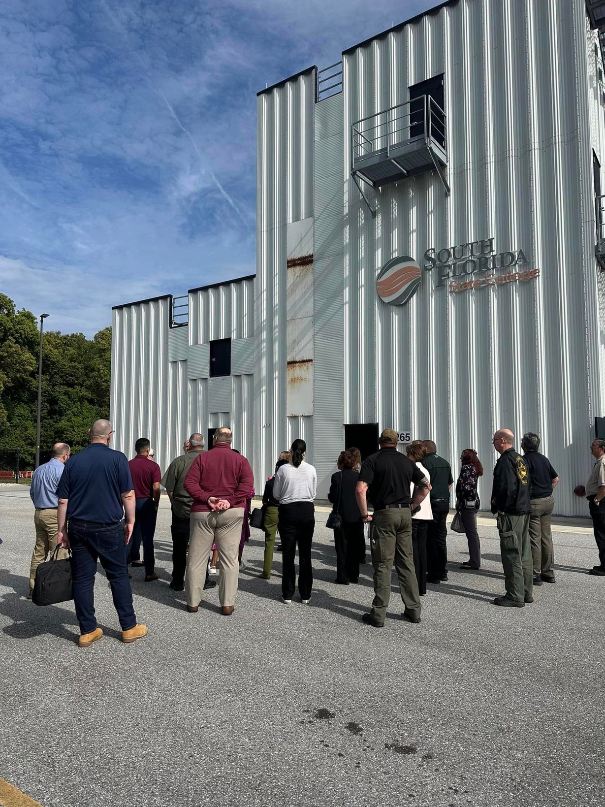 Group standing outside building with words South Florida State College