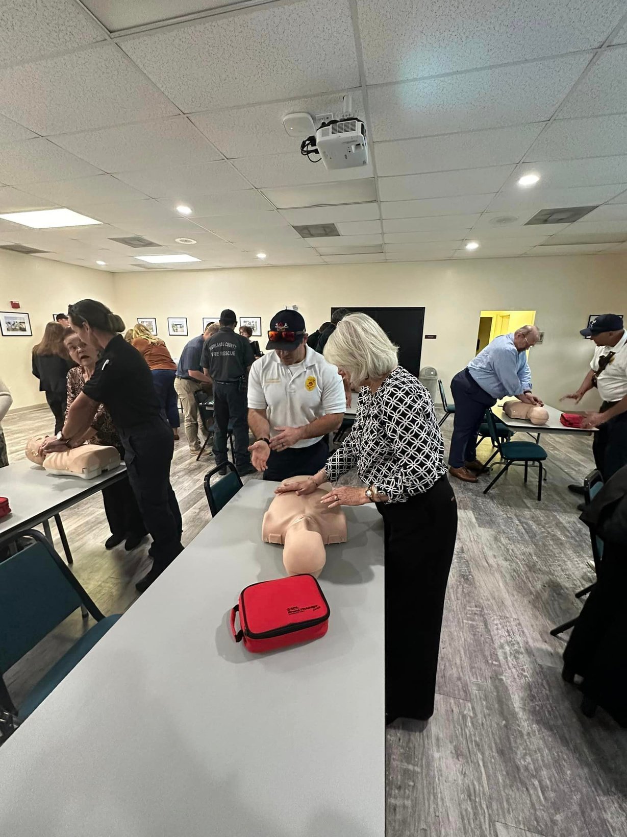 Class members practicing CPR on mannequins